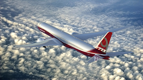 777-9X Images; K66137-03; 777x; view from left ; 777x over clouds; full plane view;